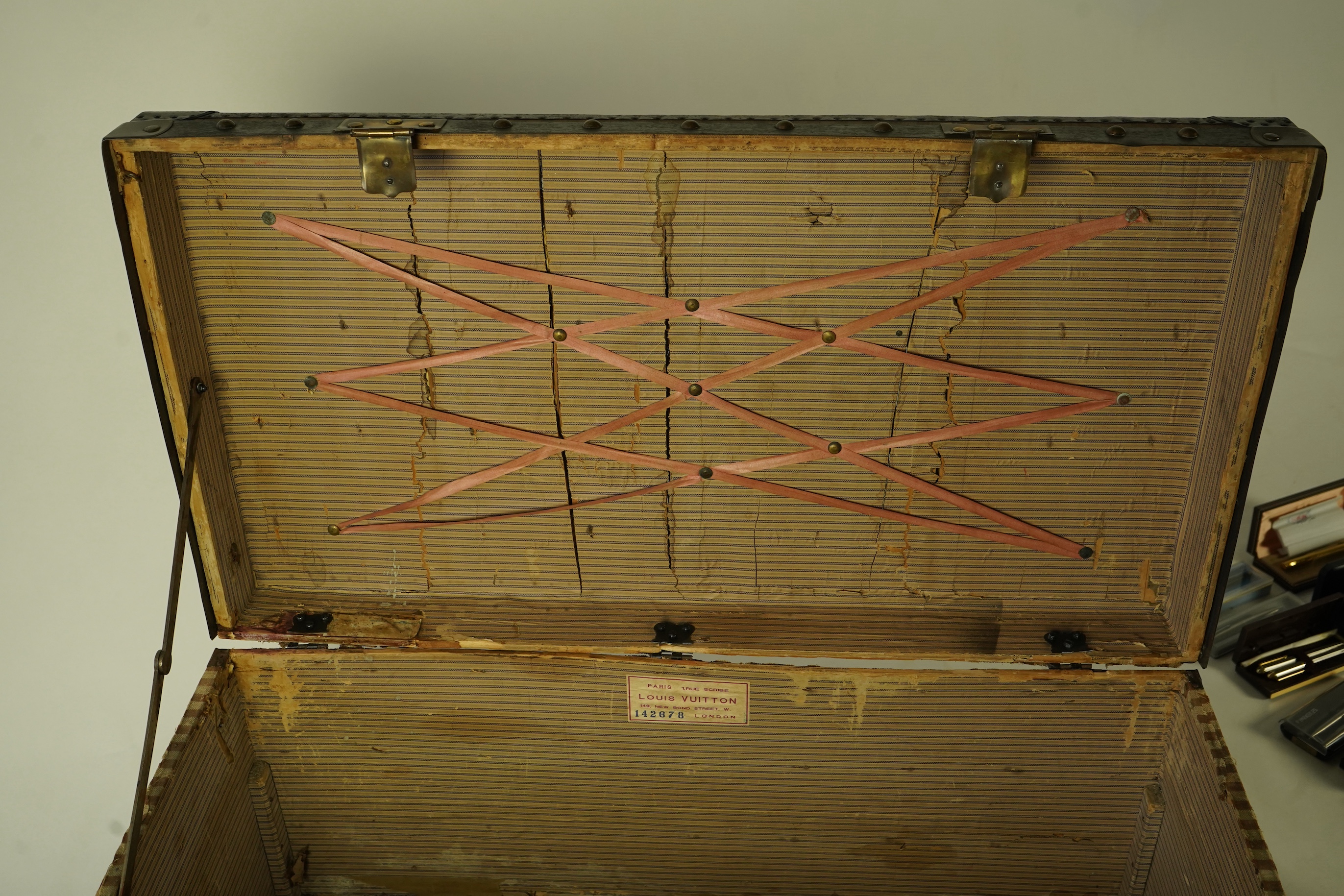 A vintage Louis Vuitton trunk with paper label to the interior numbered 142678, height 43cm, width 90cm, depth 48cm